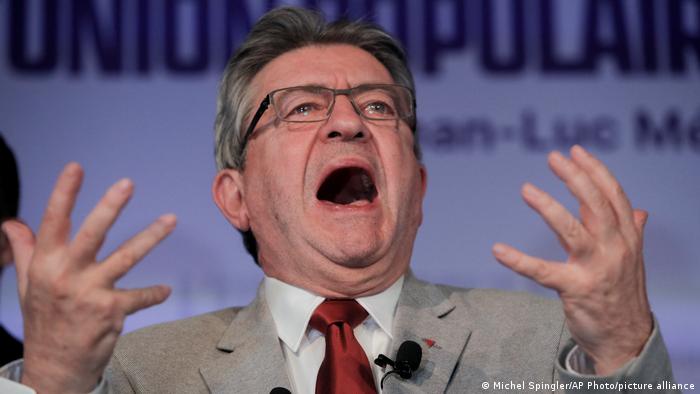 Jean-Luc Melenchon reacts to preliminary results of the first round of the presidential election in Paris, his hands in the air with a wide open mouth