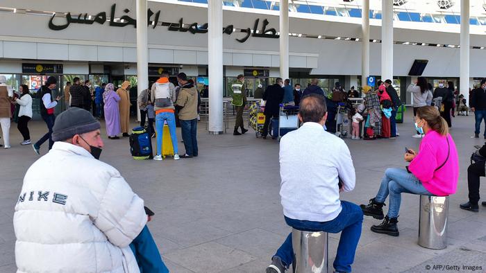  People wait for arrivals outside the Mohammed V airport in the western Moroccan city of Casablanca.