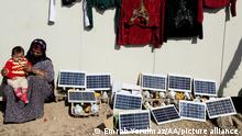 1.2.2022, Erbil, Irak,: Hazal Hidir keeps guard next to solar power panels in a refugee camp where they have no electricity supplied to them in Erbil, Iraq on February 01, 2015. A single solar power panel that is distrubuted in Bahirka Refugee Camp, lights up to 2 lamps and charges more than 1 mobile phone. Emrah Yorulmaz / Anadolu Agency