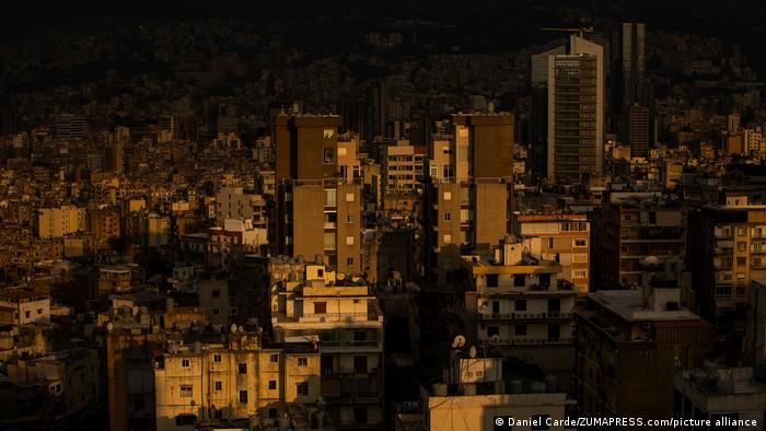 The setting sun lights buildings experiencing electrical outages in the suburbs of Beirut, Lebanon.