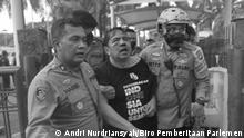 Social media activist Ade Armando was punched and kicked after he joined a protest involving hundreds of people in front of the House of Representatives complex in Jakarta on Monday. The angry mob who called Ade “government propagandist” also attempted to strip him, causing him to lose his pant at the end of the assault. Police said Ade, who teaches communication at the University of Indonesia, suffers severe injuries in the head and had to be rescued by riot officers. Bruises and blood were clearly visible around his face
