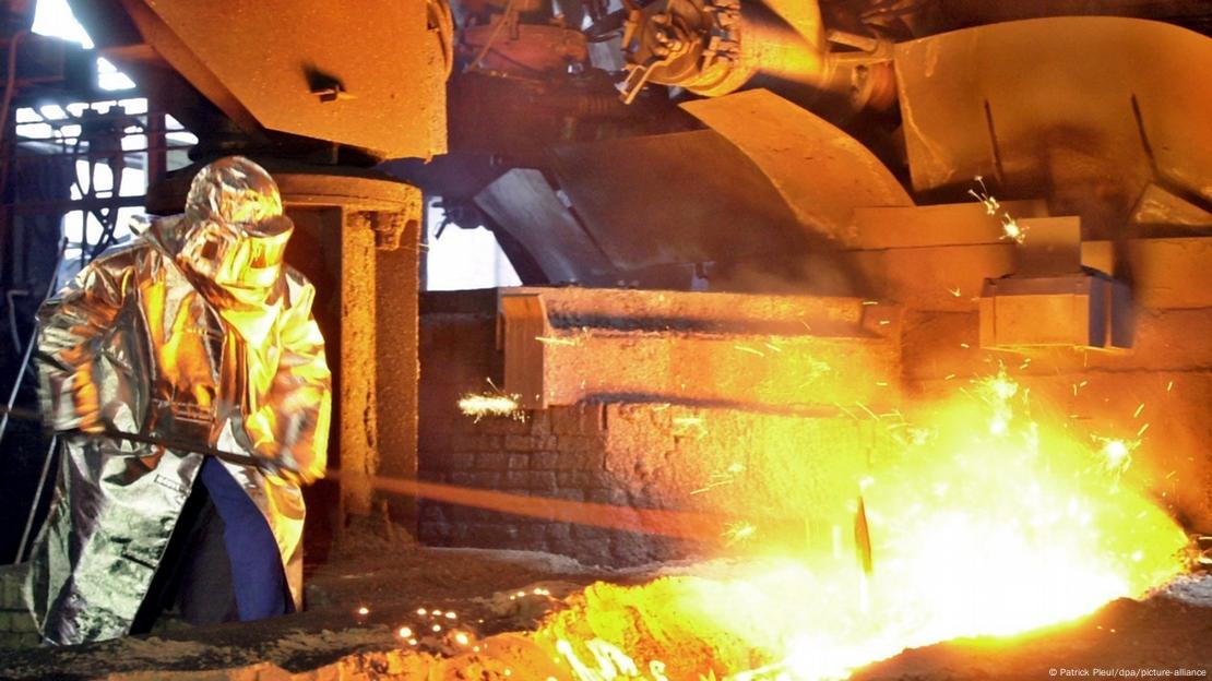 A person works at a glowing furnace in eastern Germany