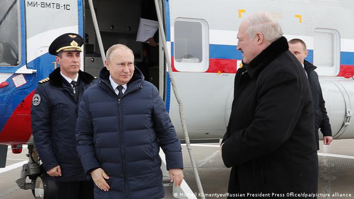 Russia's President Vladimir Putin (2nd L) and Belarusian President Alexander Lukashenko (R front) arrive by helicopter at the Vostochny