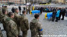  April 6, 2022, Lviv, Ukraine: Family, friends, and relatives seen standing next to the coffins of the fallen soldiers draped with the Ukrainian flag during the funeral ceremony. Funeral Service for three Ukrainian soldiers, Liubomyr Gudzelyak, sergeant Vyacheslav Ubiyvovk, and Ruslan Koval, killed by Russian forces amid the Russian invasion of Ukraine. Lviv Ukraine - ZUMAs197 20220406_zaa_s197_488 Copyright: xMykolaxTysx