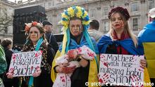 LONDON, UNITED KINGDOM - APRIL 10, 2022: Women wearing floral crowns and holding placards a doll covered in fake blood demonstrate outside Downing Street against war atrocities targeting civilians including killings and rape on the 46th day of Russian military invasion in Ukraine on April 10, 2022 in London, England. Demonstrators call on the international community to support Ukraine by supplying arms and implementing an embargo on Russian oil and gas. (Photo by WIktor Szymanowicz/NurPhoto)