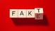 Wooden blocks spell out F A K T/E Wooden blocks spell out F A K T/E