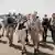 German Foreign Ministers Annalena Baerbock in a flak jacket is accompanied by German troops in the Malian city of Gao