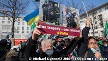 March 19, 2022, Berlin, Germany: Protesters gathered in Berlin to celebrate the 11th anniversary of the Syrian Revolution. They also criticized the Russian invasion, especially Russian aggression in Syria, for which Putin and Assad are responsible. The protesters shouted freedom for Ukraine, Slava Ukraini, and held signs up with One tragedy, one criminal. A few Ukrainian flags were visible at the protest. (Credit Image: Â© Michael Kuenne/PRESSCOV via ZUMA Press Wire