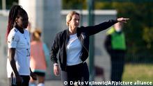 Germany's coach Martina Voss-Tecklenburg gives instructions during the Women's World Cup Group H qualifying soccer match between Serbia and Germany at Sports Center of FA of Serbia stadium in Stara Pazova, near Belgrade, Serbia, Tuesday, April 12, 2022. (AP Photo/Darko Vojinovic)