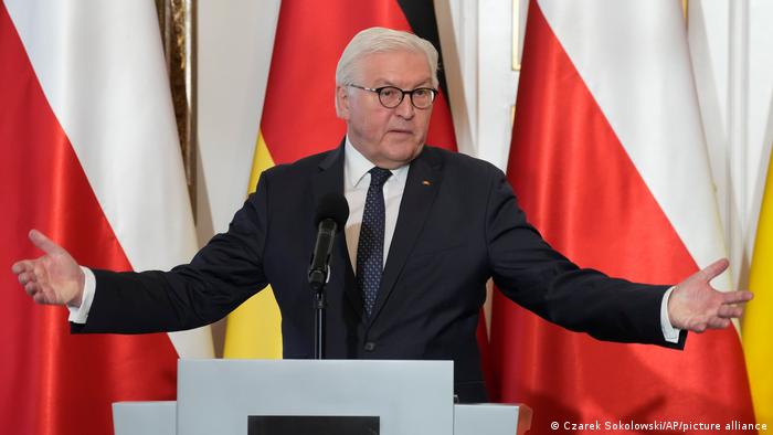 Frank-Walter Steinmeier with his arms outspread