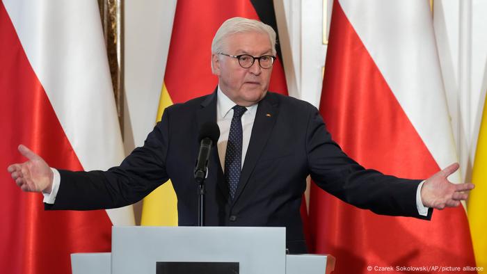 Frank-Walter Steinmeier with his arms outspread