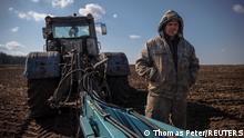 Local farm worker Vladimir takes a break from ploughing a field near the village of Yakovlivka after it was hit by an aerial bombardment outside Kharkiv, as Russia's attack on Ukraine continues, April 5, 2022. We continue to work as good as we can despite the war. We can’t get to some of our fields, there are mines or they are fighting. It’s crazy how one person (Russian President Vladimir Putin) can turn our whole world upside down, Vladimir said. REUTERS/Thomas Peter SEARCH YAKOVLIVKA FOR THIS STORY. SEARCH WIDER IMAGE FOR ALL STORIES. TPX IMAGES OF THE DAY