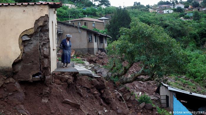 A woman stands at her front door after heavy rains caused flood damage in KwaNdengezi, Durban, South Africa
