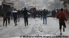 April 13, 2022, Nablus, West Bank, Palestinian Territory: Palestinian protesters clash with Israeli forces, in the West Bank city of Nablus on April 13, 2022. A Palestinian was killed while 17 others were injured during an Israeli military raid into the West Bank city of Nablus and nearby towns and villages this morning, according to the Ministry of Health (Credit Image: © Shadi Jarar'Ah/APA Images via ZUMA Press Wire