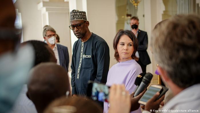 German Foreign Minister Annalena Baerbock answers questions standing alongside Mali's acting Foreign Minister Abdoulaye Diop