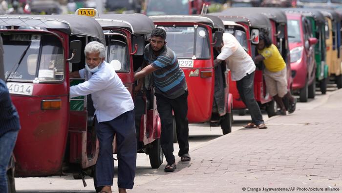 Auto rickshaw drivers queue up to buy petrol near a station in Colombo, Sri Lanka