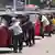 Sri Lankan auto rickshaw drivers queue up to buy petrol near a fuel station in Colombo, Sri Lanka, Wednesday, April 13, 2022. 
