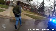 Patrick Lyoya runs from a Grand Rapids Police officer during a traffic stop, shortly before he was shot dead by the officer during a scuffle on a suburban front lawn in Grand Rapids, Michigan, U.S. April 4, 2022 in a still image from police body camera video. Video taken April 4, 2022. Grand Rapids Police/Handout via REUTERS 
