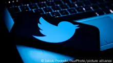 Twitter logo displayed on a phone screen and a laptop keyboard are seen in this illustration photo taken in Krakow, Poland on April 9, 2022. (Photo by Jakub Porzycki/NurPhoto)