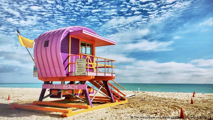 A pink lifeguard structure on the beach in Miami Beach.