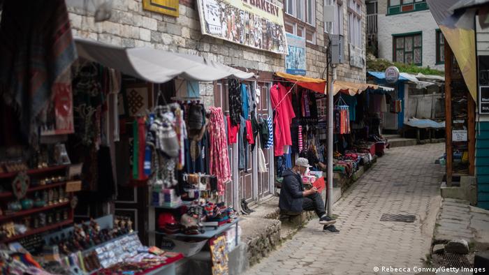 A Nepali shop owner waits for customers as Nepal's tourism industry struggles to recover from the COVID pandemic