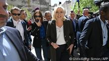 French far-right party Rassemblement National (RN) presidential candidate Marine Le Pen (C) arrives for a campaign visit in Lauris, South of France, on April 15, 2022. - Marine Le Pen will face French President and liberal party La Republique en Marche (LREM) candidate for re-election Emmanuel Macron in a run-off vote on April 24, 2022, after first round voting on April 10. (Photo by CHRISTOPHE SIMON / AFP)