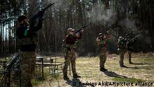 Ukrainian soldiers perform a rifle volley during the funeral of Anatoliy Kolesnikov, 30, and Oleksandr Mozheiko, 31, both territorial defense soldiers who were killed by Russian, in Irpin, in the outskirts of Kyiv, Ukraine, Friday, April 15, 2022. (AP Photo/Rodrigo Abd)