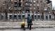 A resident looks at a residential building damaged in heavy fighting in Mariupol A resident looks at a residential building damaged in heavy fighting in Mariupol