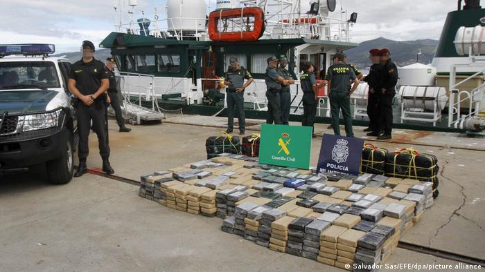 Members of the Spanish National Civil Guard stand next to cocaine bundles in the port of Vigo, Spain