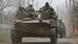 Russian soldiers ride on top of a tank with a Z marking Russian soldiers ride on top of a tank with a Z marking