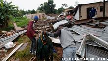 People find their late relative's church uniform in the rubble of a building, which was destroyed during flooding leaving several people dead, at the KwaNdengezi Station, near Durban, South Africa, April 16, 2022. REUTERS/Rogan Ward
