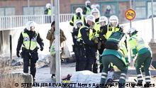 Police and ambulance personnel carry an injured man who was shot in the leg during rioting in Norrkoping, Sweden on April 17, 2022. - Plans by a far-right group to publicly burn copies of the Koran sparked violent clashes with counter-demonstrators for the third day running in Sweden, police said on April 17, 2022. - Sweden OUT (Photo by Stefan JERREVANG / various sources / AFP) / Sweden OUT (Photo by STEFAN JERREVANG/TT News Agency/AFP via Getty Images)