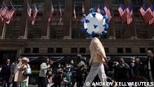A person dressed in a costume symbolising COVID-19 walks on a makeshift runway during the annual Easter Parade and Bonnet Festival on 5th Ave in Manhattan, New York City, U.S., April 17, 2022. REUTERS/Andrew Kelly
