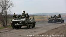 Russian military vehicles move on a highway in an area controlled by Russian-backed separatist forces near Mariupol, Ukraine, Monday, April 18, 2022. Mariupol, a strategic port on the Sea of Azov, has been besieged by Russian troops and forces from self-proclaimed separatist areas in eastern Ukraine for more than six weeks. (AP Photo/Alexei Alexandrov)