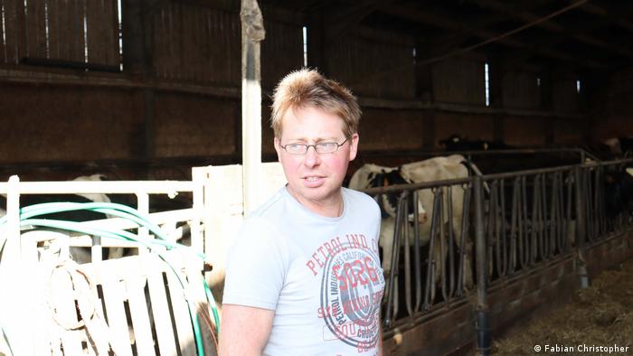 Belgian farmer Kris Heirbaut pictured inside the cow stable in his farm.