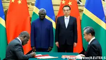 FILE PHOTO: (L-R) Solomon Islands Prime Minister Manasseh Sogavare, Solomon Islands Foreign Minister Jeremiah Manele, Chinese Premier Li Keqiang and Chinese State Councillor and Foreign Minister Wang Yi attend a signing ceremony at the Great Hall of the People in Beijing, China October 9, 2019. REUTERS/Thomas Peter/File Photo