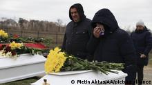 BUCHA, UKRAINE - APRIL 19: Relatives mourn during the funeral at Bucha Cemetery for two children and their mother exhumed from a mass grave at the backyard of St Andrew church in Bucha, Ukraine on April 19, 2022. Metin Aktas / Anadolu Agency