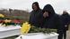Relatives mourn during the funeral at Bucha Cemetery for two children and their mother exhumed from a mass grave Relatives mourn during the funeral at Bucha Cemetery for two children and their mother exhumed from a mass grave