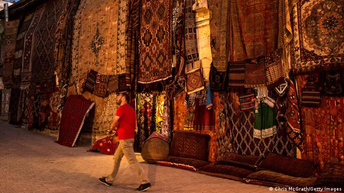 A man walks past a rug shop in Nevsehir, Turkey