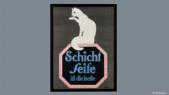 A white cat licks its paw on an advertising poster