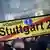 Demonstrators hold a banner with the words Stuttgart 21 crossed through in red