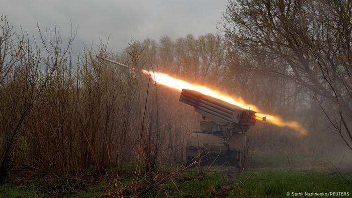 Multiple launch rocket system BM-21 fires a salvo