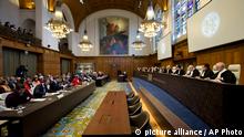 Delegations of Nicaragua, front left, and Colombia, rear left, listen as the World Court delivered its judgment on the preliminary objections in the case between Nicaragua and Colombia over alleged violations of sovereign rights and maritime spaces in the Caribbean Sea in The Hague, Netherlands, Thursday, March 17, 2016. (AP Photo/Peter Dejong)