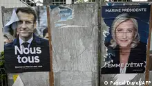Campaign posters of far-right Party (RN) presidential candidate Marine Le Pen (R), and incumbent President and candidate for his reelection Emmanuel Macron (L) are displayed on an electoral board in Montpellier, southern France, on April 21, 2022. - President Emmanuel Macron and far-right rival Marine Le Pen launched a final push for votes in working class heartlands of France after a pre-election debate on April 20, 2022 marked by bitter clashes. (Photo by Pascal GUYOT / AFP)