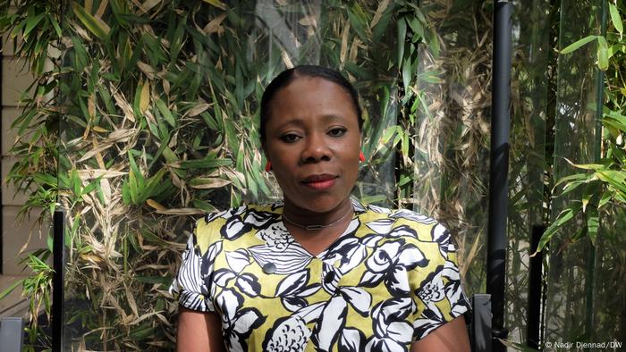 Rosine Nahounou standing in front of some plants