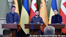 Spain's Prime Minister Pedro Sanchez (L) and Denmark's Prime Minister Mette Frederiksen (R) listen as Ukraine's President Volodymyr Zelensky (C) delivers a speech during their press conference in Kyiv on April 21, 2022. (Photo by Genya SAVILOV / AFP) (Photo by GENYA SAVILOV/AFP via Getty Images)