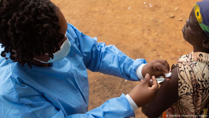 A woman gets vaccinated