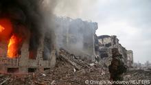 A service member of pro-Russian troops stands in front of the destroyed administration building of Azovstal Iron and Steel Works during Ukraine-Russia conflict in the southern port city of Mariupol, Ukraine April 21, 2022. REUTERS/Chingis Kondarov