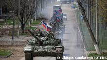 An armoured convoy of pro-Russian troops moves along a road during Ukraine-Russia conflict in the southern port city of Mariupol, Ukraine April 21, 2022. REUTERS/Chingis Kondarov