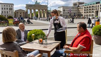 waiter serving guests in cafe by the Brandenburg Gate